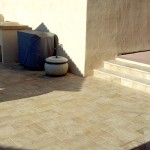 Stone flooring for patio and steps with BBQ and chair in corner